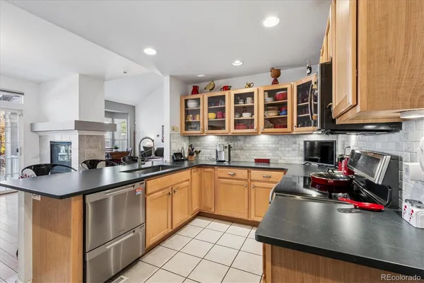 a kitchen with stainless steel appliances granite countertop a sink stove and cabinets