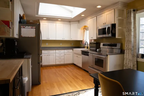 a kitchen with a stove a sink and a microwave