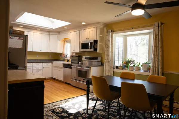a kitchen with stainless steel appliances granite countertop a refrigerator a stove and a sink