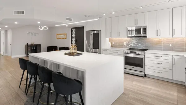 a kitchen with stainless steel appliances kitchen island granite countertop a stove a sink a dining table and chairs