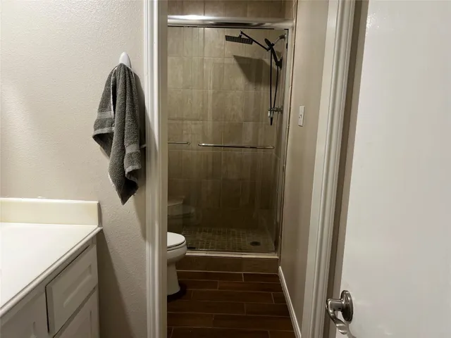 a bathroom with a shower and a mirror