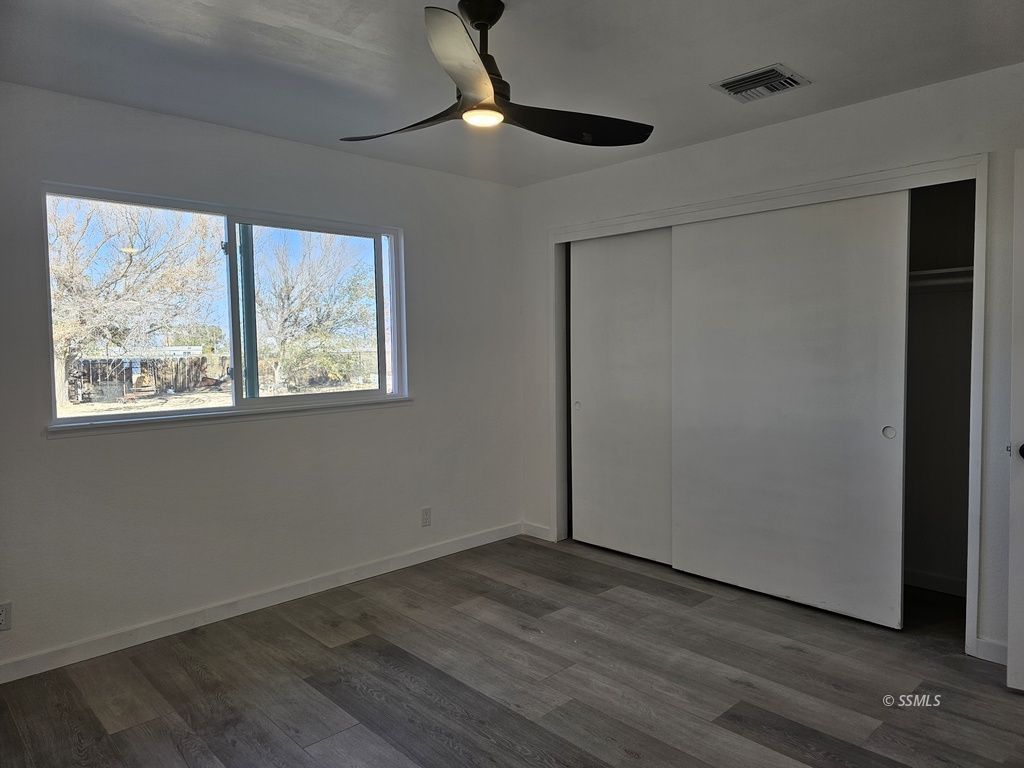 3644 Alene Avenue Ridgecrest, CA 93555 - Photo 8 of 22 a view of an empty room with wooden floor and a window