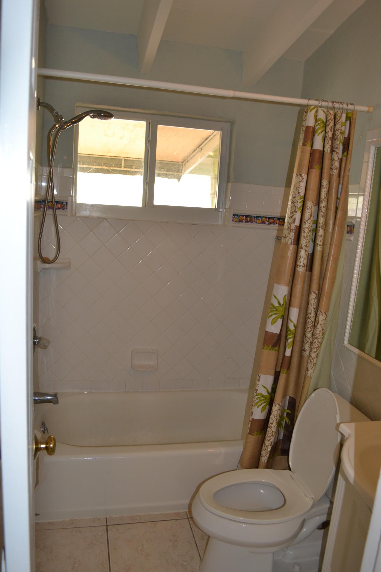 39 Bass Avenue Key Largo, FL 33037 - Photo 19 of 25 a white toilet sitting next to a bath tub and shower