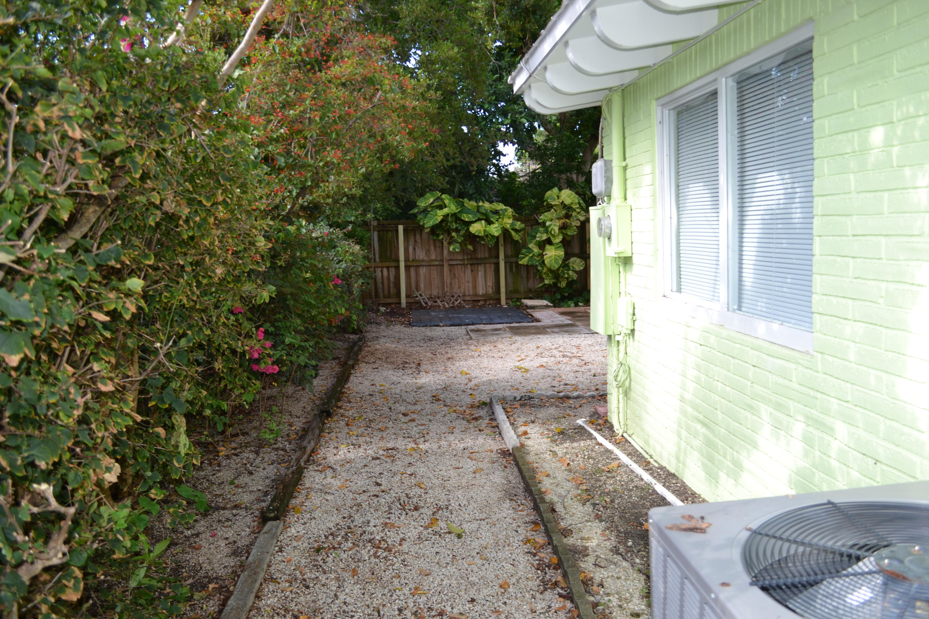 39 Bass Avenue Key Largo, FL 33037 - Photo 3 of 25 a view of a backyard with potted plants