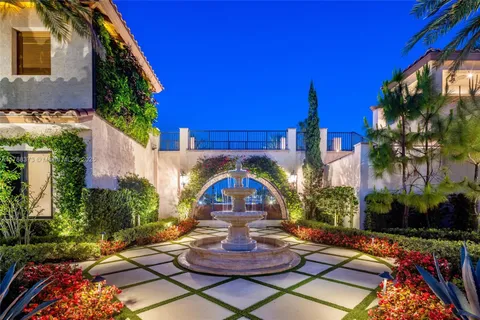 a front view of a house with patio outdoor seating and lake view