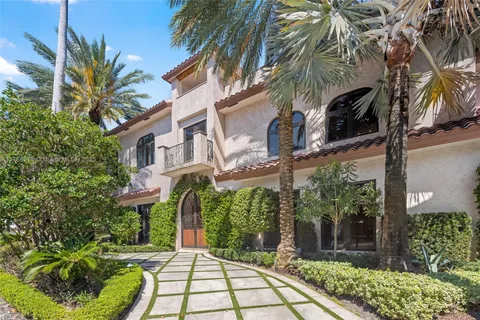 a front view of multiple houses with yard