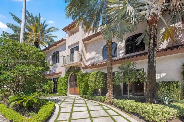 a front view of multiple houses with yard