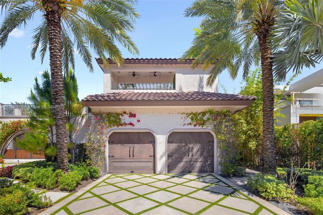 a view of a house with a window and potted plants