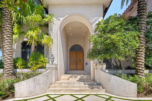 a view of a patio with couches table and chairs potted plants and palm trees