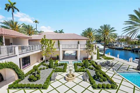 a view of a patio with couches table and chairs with wooden fence