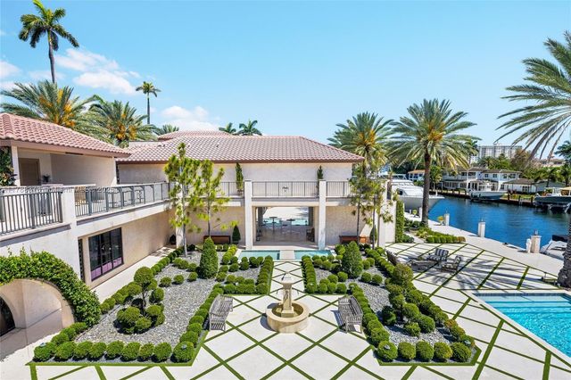 a view of a patio with couches table and chairs with wooden fence