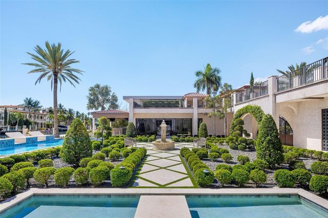a living room with patio furniture and a floor to ceiling window