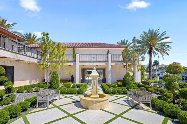 a front view of a house with fountain