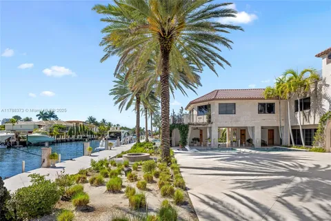 a view of a swimming pool with a lounge chair and palm trees