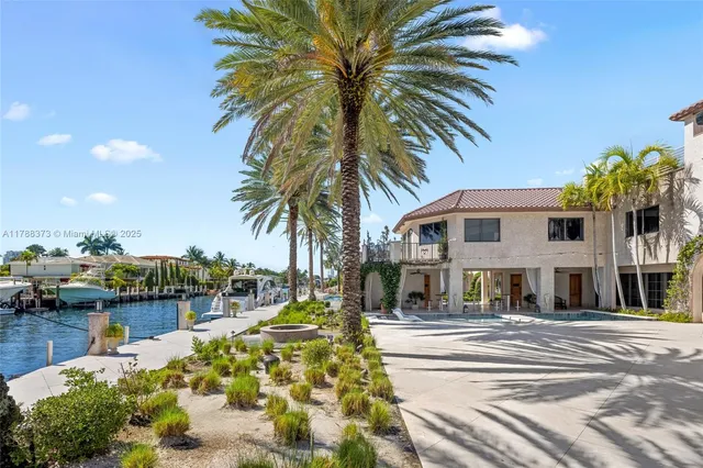 a view of a swimming pool with a lounge chair and palm trees