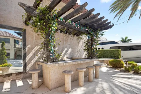 a view of a house with pool fire pit a patio and a garden