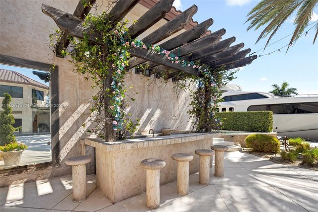 a view of a house with pool fire pit a patio and a garden