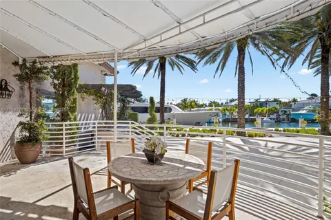a view of a house with swimming pool and sitting area