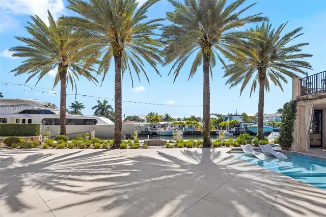 a view of a backyard with plants and swimming pool