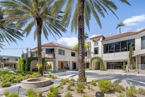 a dining room with furniture and a floor to ceiling window