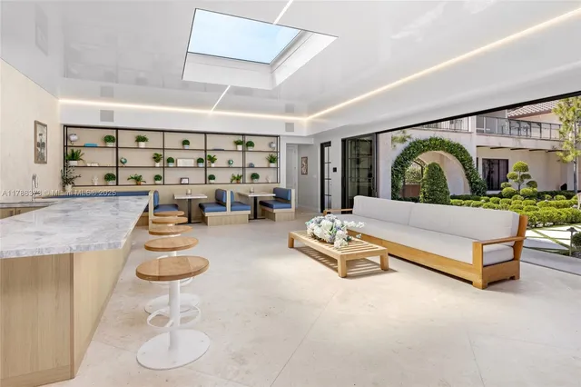 a view of a patio with couches table and chairs and potted plants