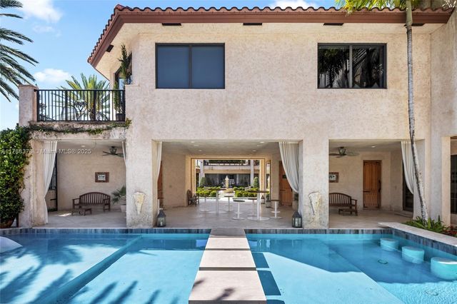 a dining room with furniture a chandelier and window