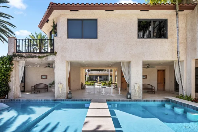 a dining room with furniture a chandelier and window