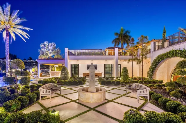 a view of a swimming pool with lawn chairs under an umbrella