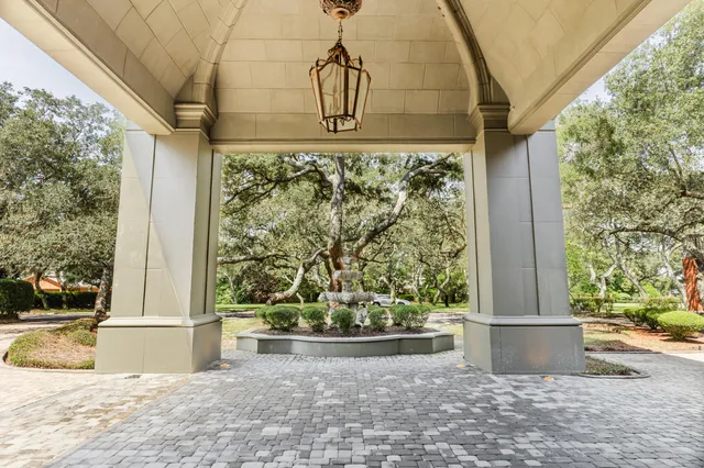 a view of a livingroom with wooden floor fireplace and windows