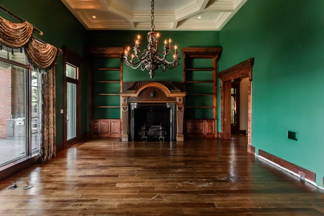 a view of a living room hardwood floor and a kitchen