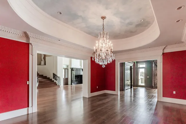 a view of an entryway with wooden floor and door