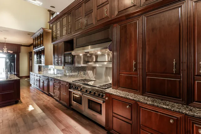 a view of a room with wooden floor staircase and a large window
