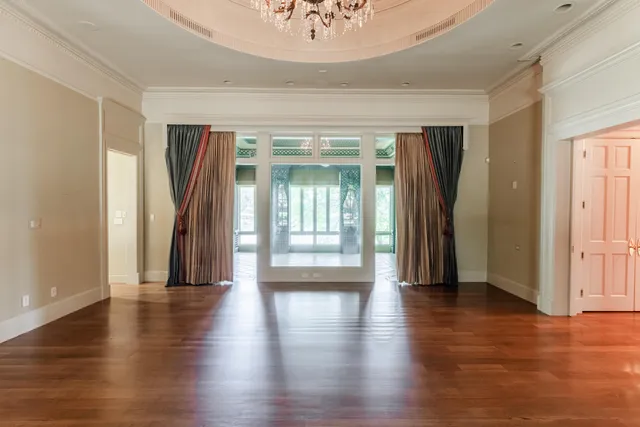 a view of an empty room with a fireplace and a large window