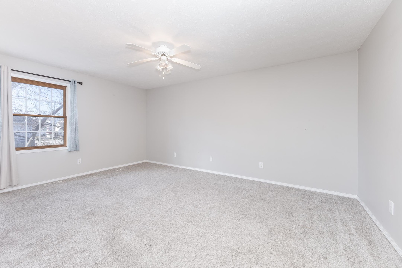 1321 Beacon Hill Court Normal, IL 61761 - Photo 15 of 45 an empty room with a window and a ceiling fan