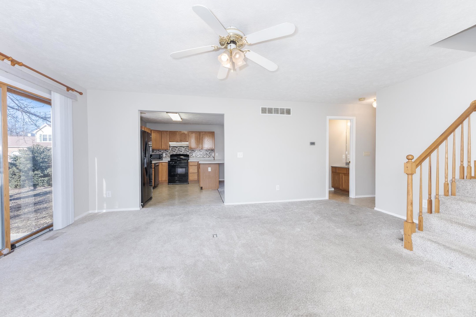 1321 Beacon Hill Court Normal, IL 61761 - Photo 7 of 45 an empty room with chandelier fan and windows