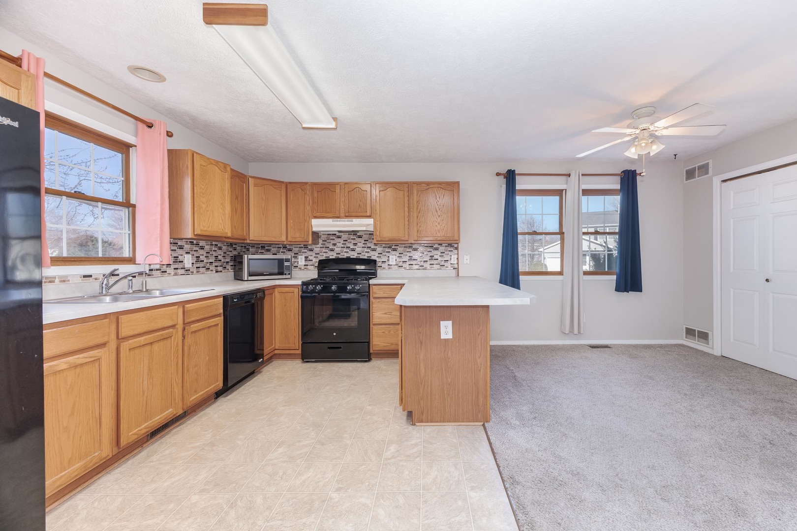 1321 Beacon Hill Court Normal, IL 61761 - Photo 9 of 45 a kitchen with stainless steel appliances granite countertop a stove a sink dishwasher a refrigerator and white cabinets with wooden floor