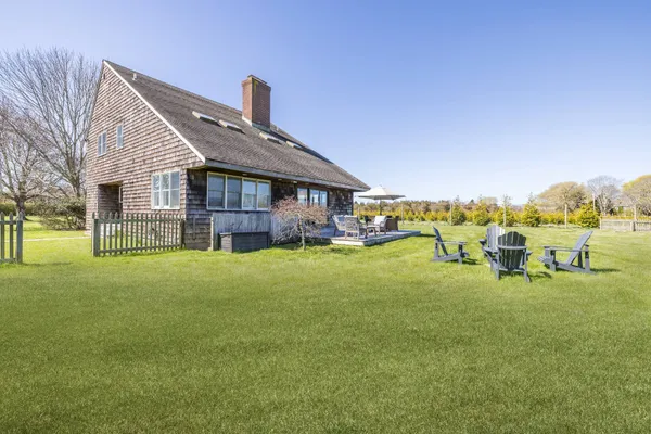 a view of a house with a yard patio and sitting area