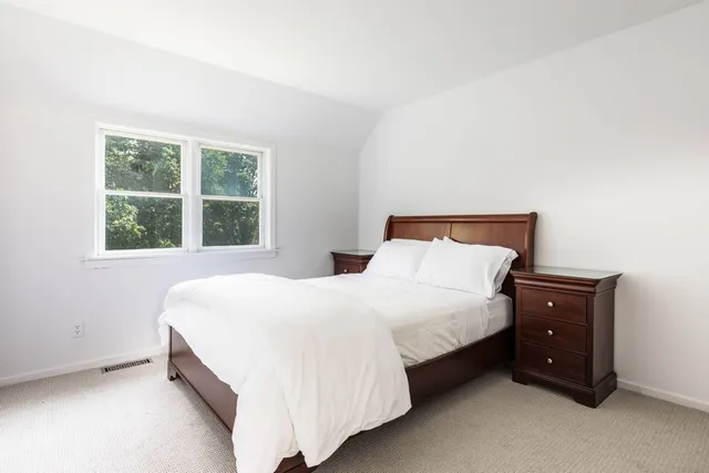 a bedroom with a bed and window