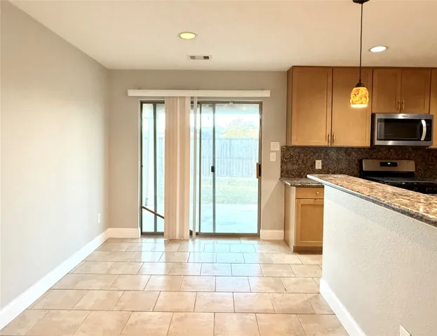a view of a kitchen with a sink and a window
