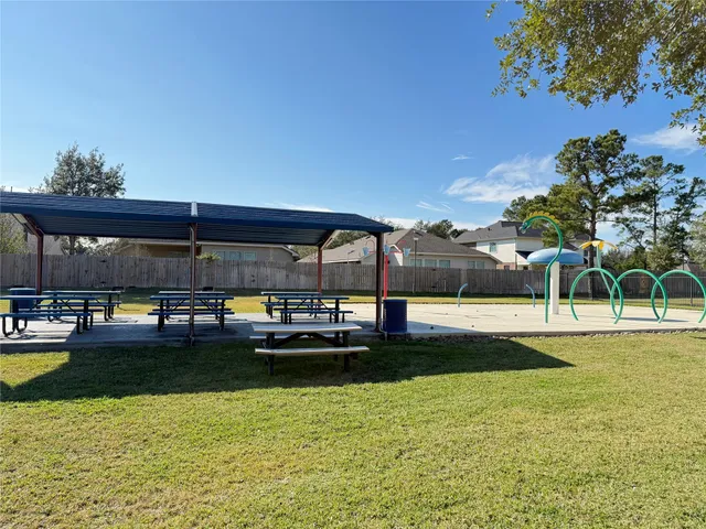 a view of swimming pool with lawn chairs and potted plants