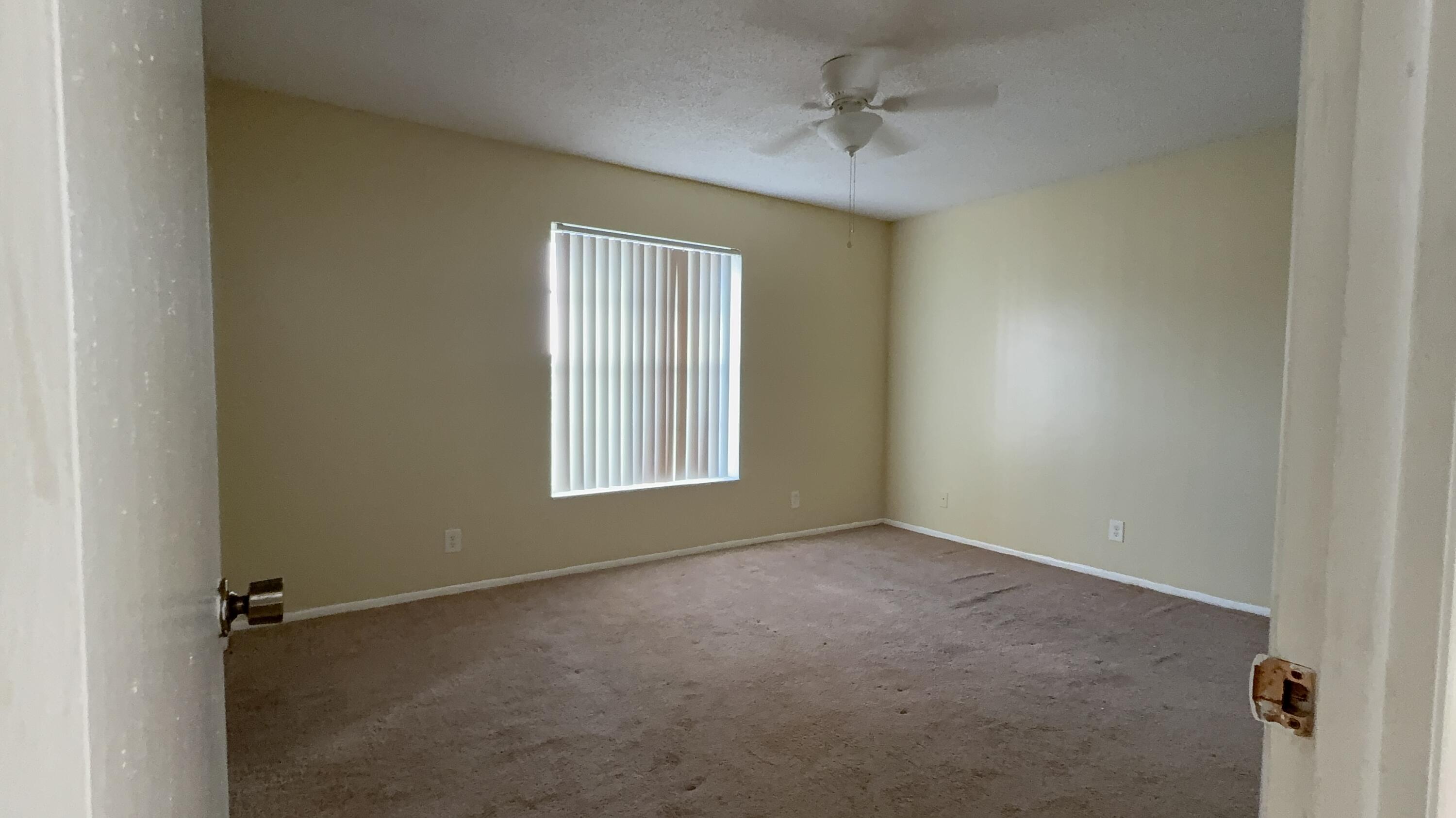 12009 Poinciana Boulevard, Unit 202 Royal Palm Beach, FL 33411 - Photo 13 of 24 an empty room with a window