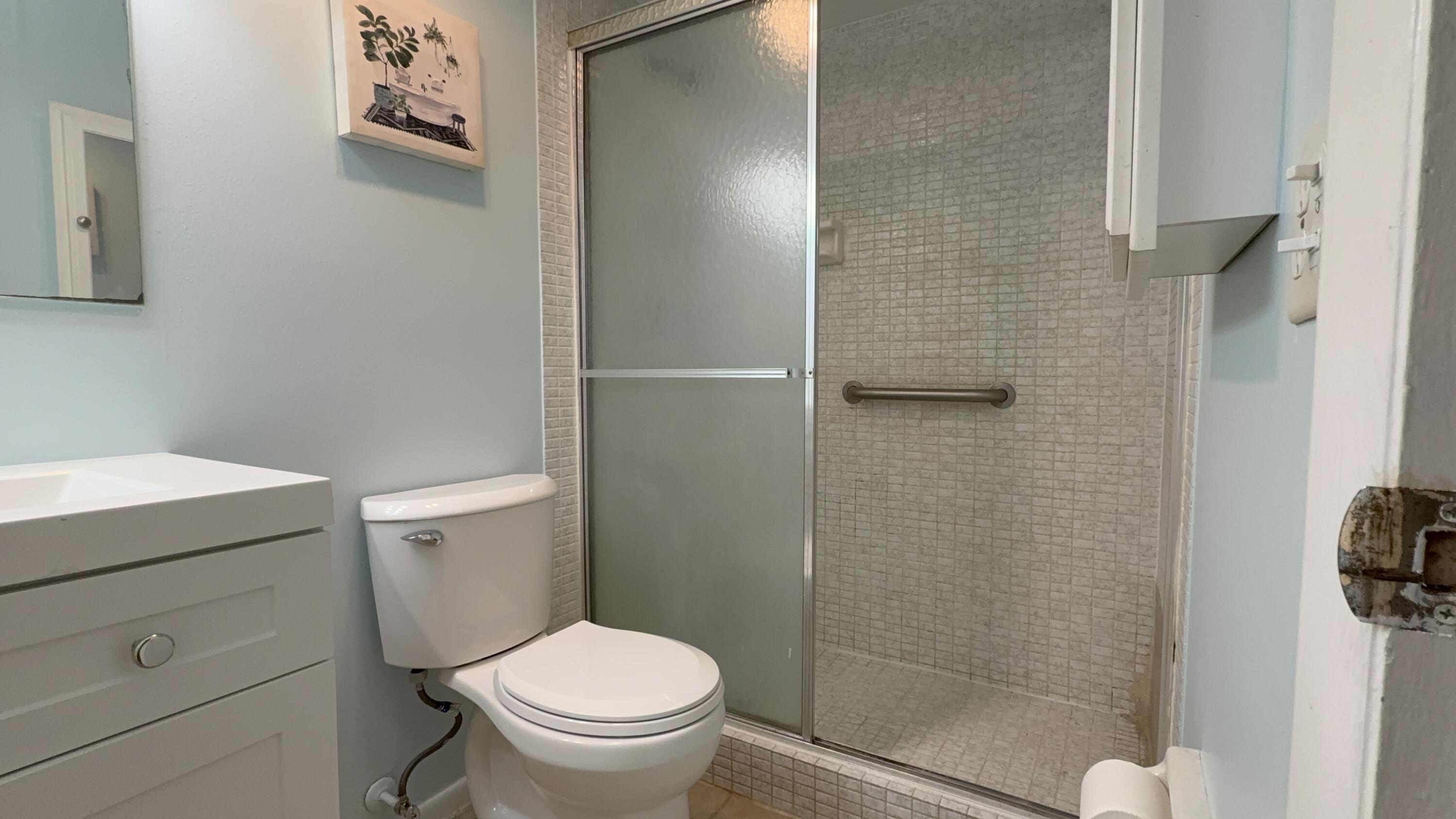 12009 Poinciana Boulevard, Unit 202 Royal Palm Beach, FL 33411 - Photo 15 of 24 a white toilet sitting next to a shower