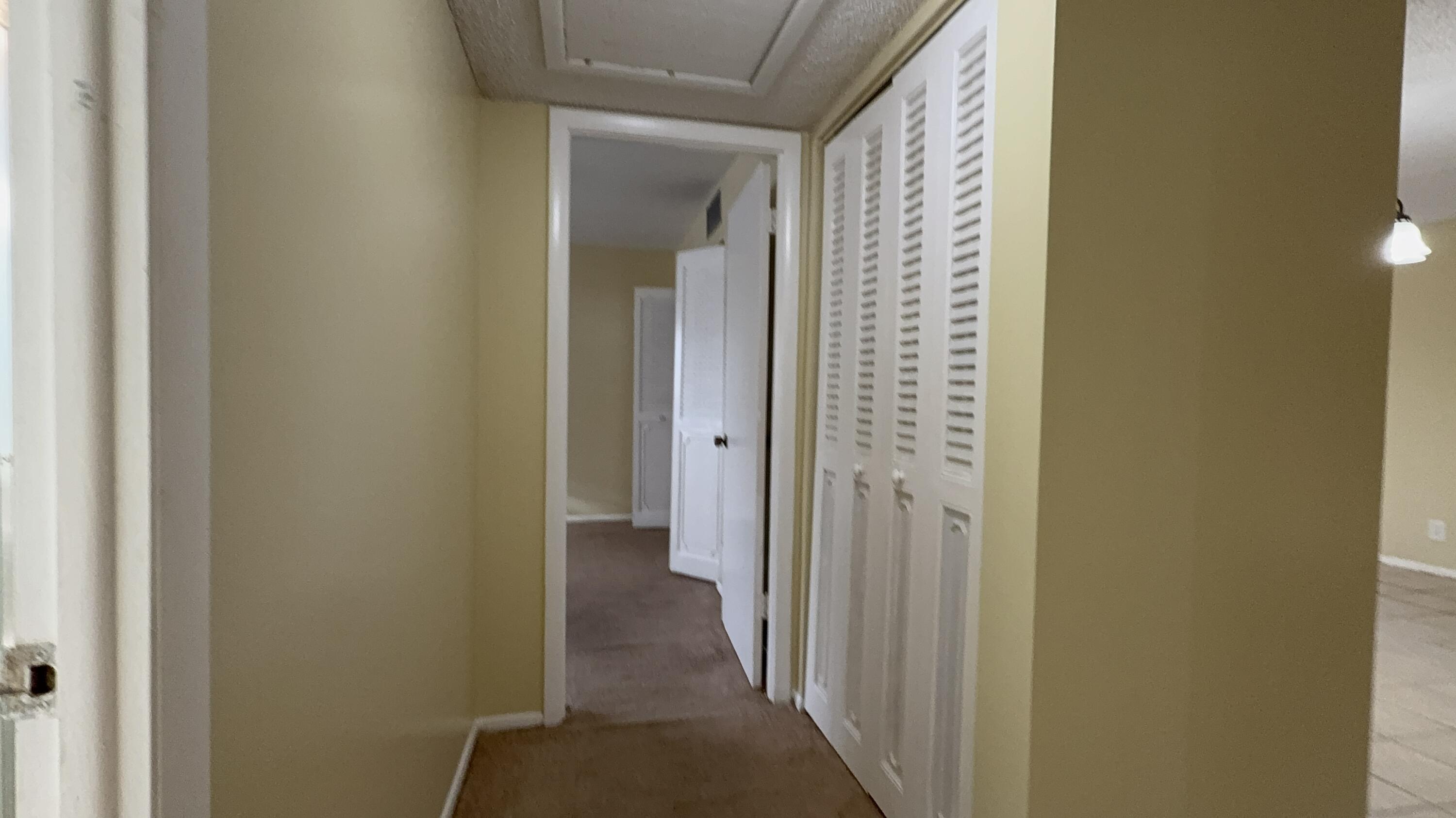 12009 Poinciana Boulevard, Unit 202 Royal Palm Beach, FL 33411 - Photo 17 of 24 a view of a bathroom from a corridor