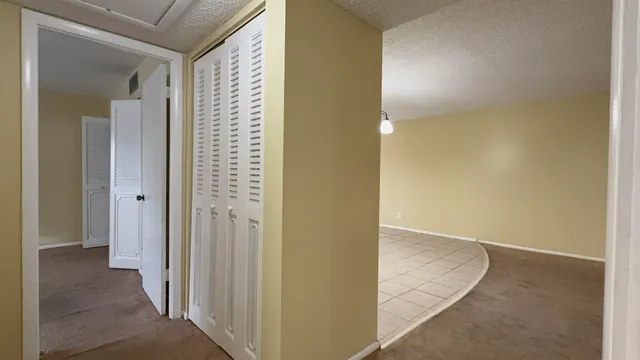 an empty room with a ceiling fan and a bathroom