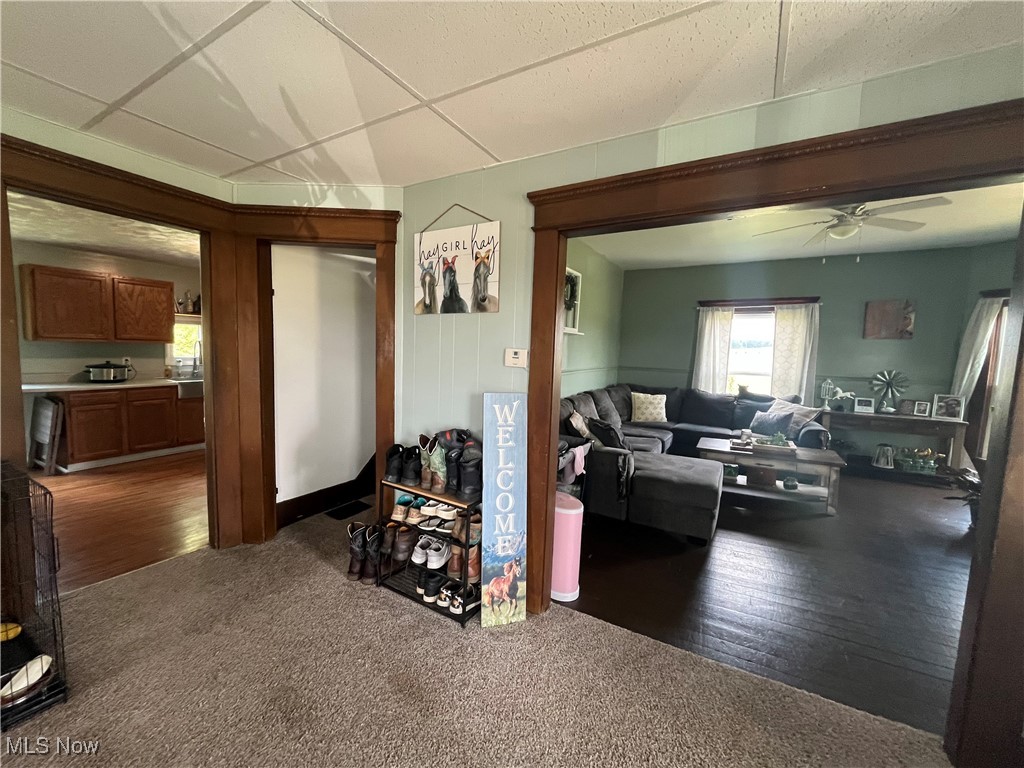 73475 Broadhead Road Kimbolton, OH 43749 - Photo 10 of 30 Living room featuring ceiling fan, a drop ceiling, and dark hardwood / wood-style flooring