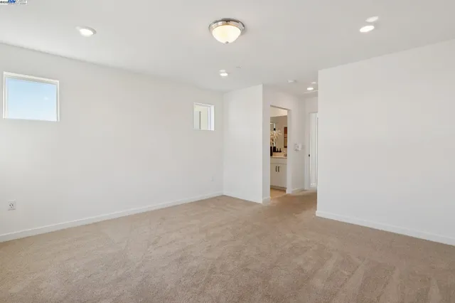an empty room with an entryway and chandelier