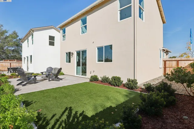 a view of a chair and table on the garden