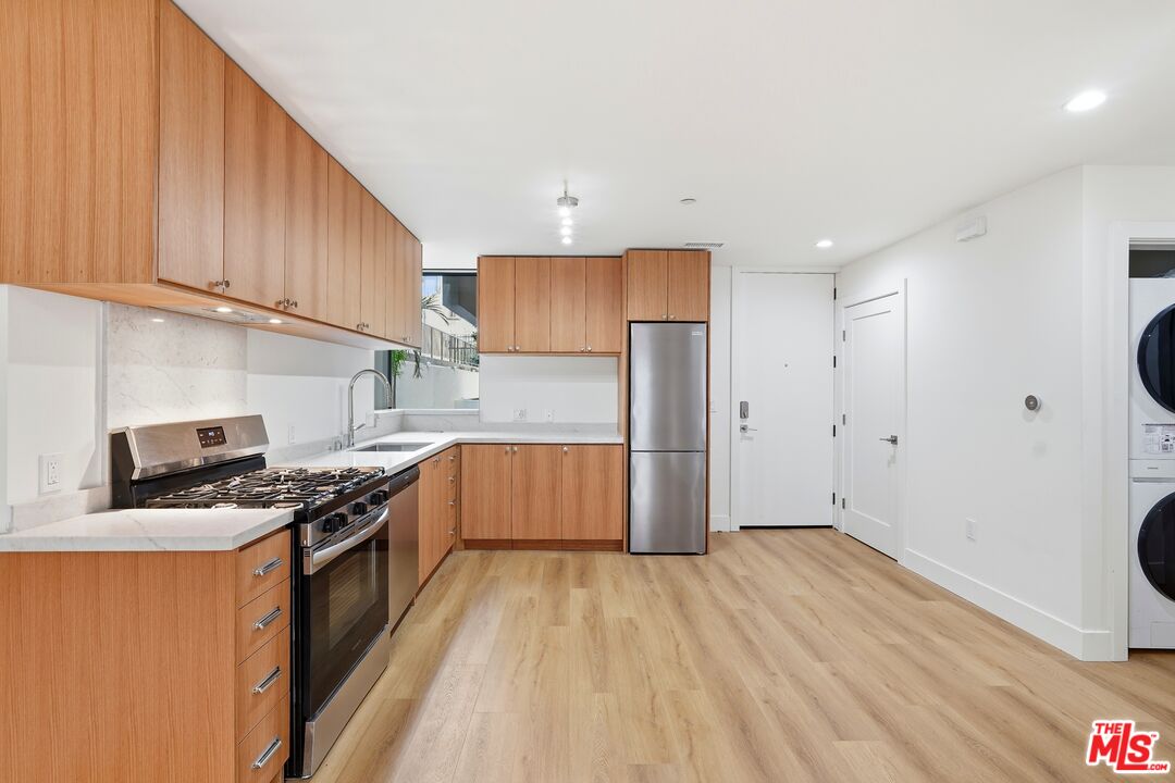 1822 Overland Avenue, Unit 103 Los Angeles, CA 90025 - Photo 2 of 10 a kitchen with stainless steel appliances granite countertop a stove cabinets and wooden floor
