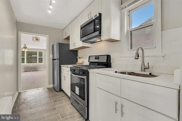 a kitchen with stainless steel appliances a stove microwave and refrigerator
