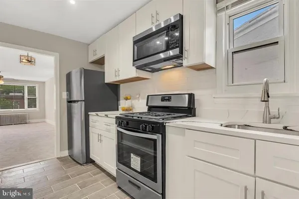 a kitchen with stainless steel appliances granite countertop a stove and a sink